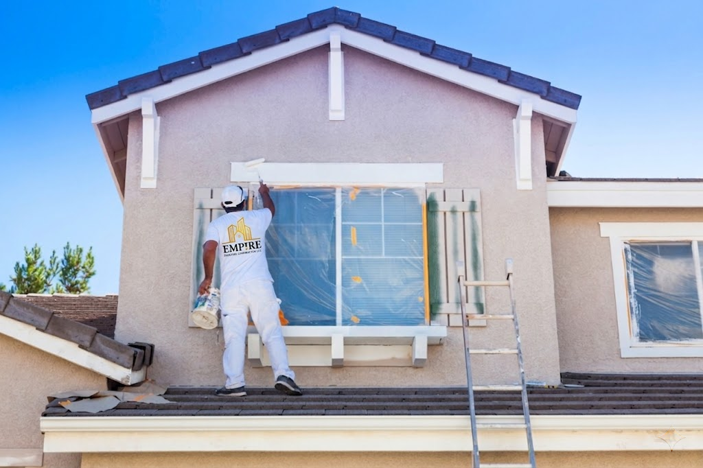 Professional house painters carefully cutting in edges around a residential window